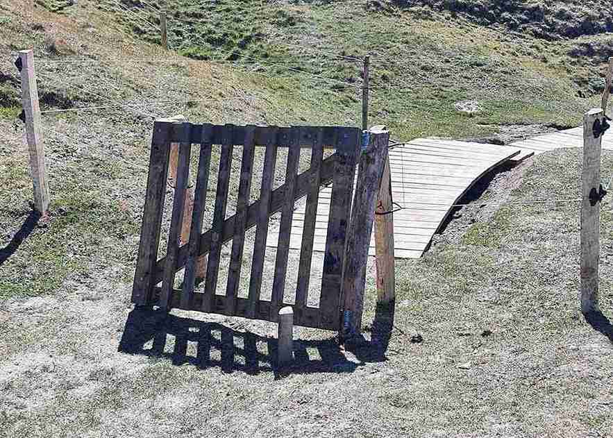 Op de voorgrond is een klephek te zien. Op de achtergrond is een houten trap te zien